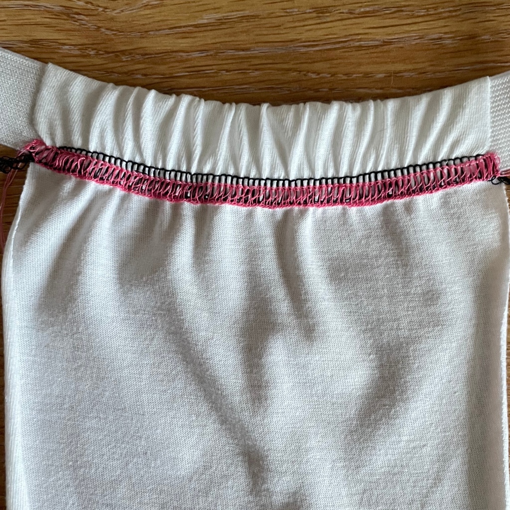 Attaching elastic to create a waistband with a cover stitch